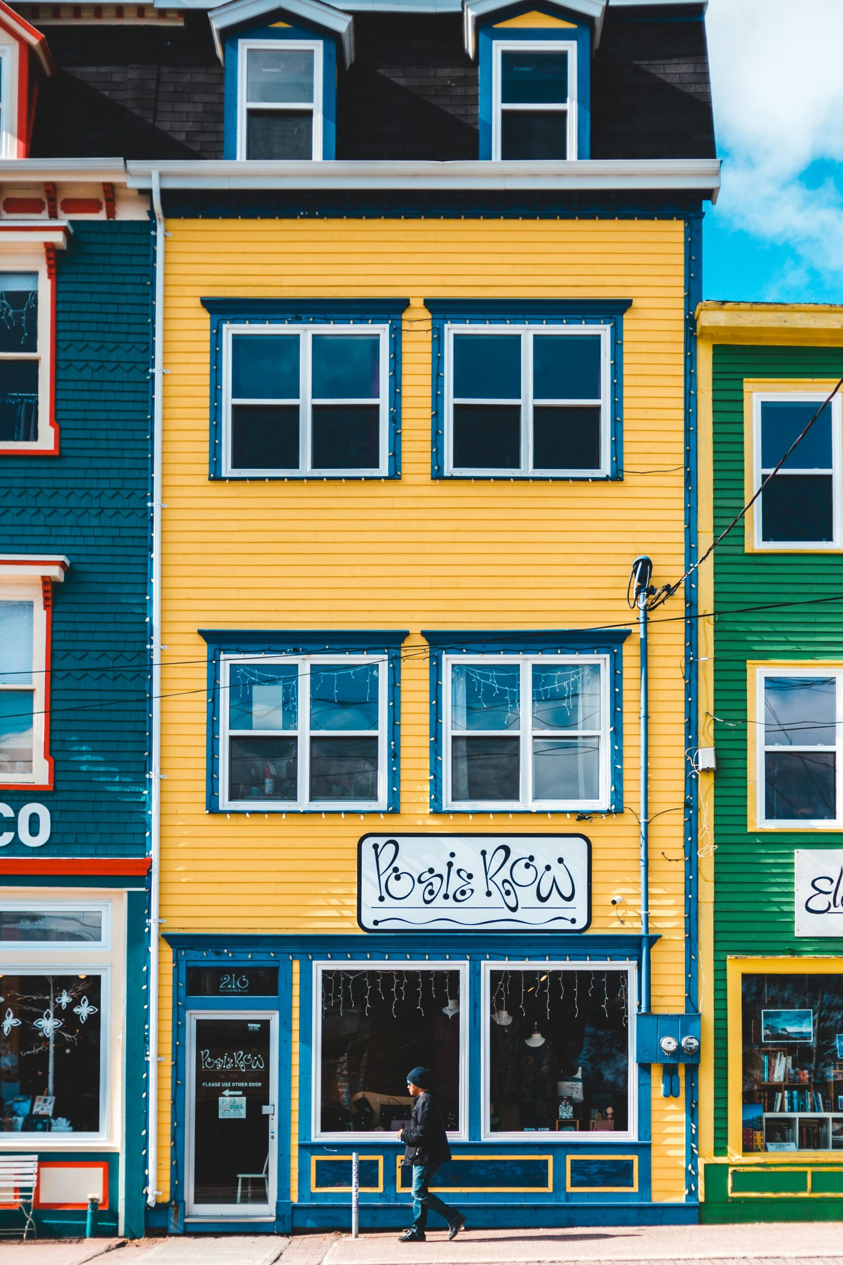 Vibrant street view featuring colorful buildings and a pedestrian in an urban setting.